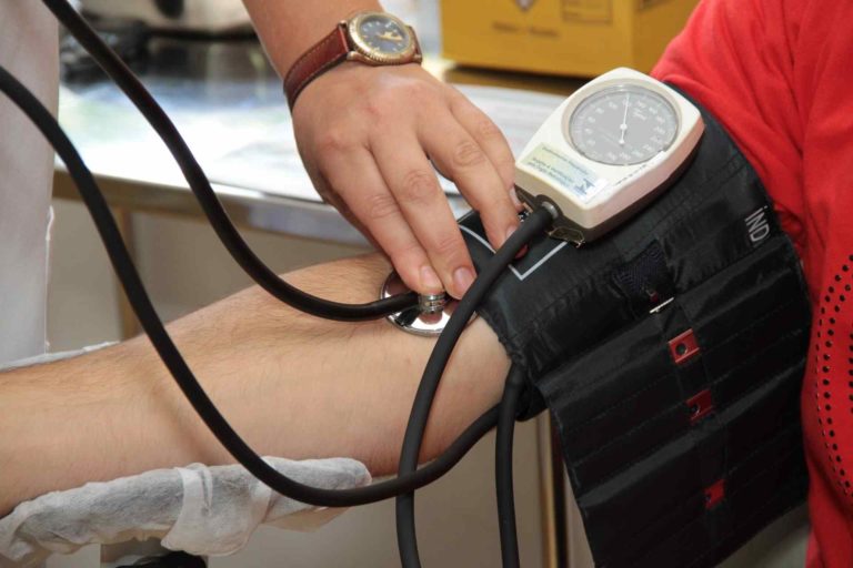 Occupational Health Clinic - A nurse taking a blood pressure reading.